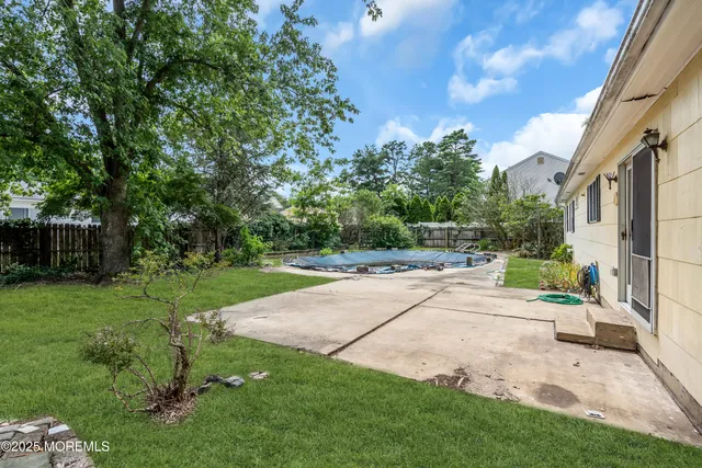 a view of a backyard with sitting area