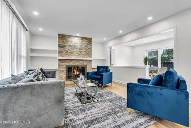 a living room with fireplace furniture and a flat screen tv