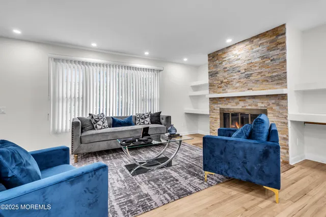 a living room with furniture and a fireplace