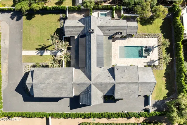 an aerial view of a house with a yard