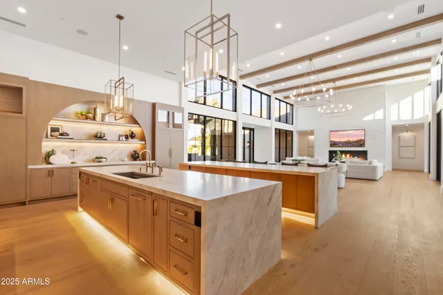 a large kitchen with stainless steel appliances a stove and a window