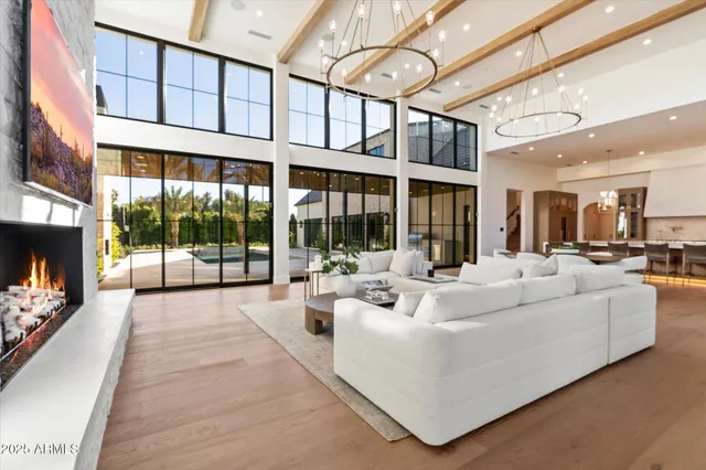 a large kitchen with stainless steel appliances granite countertop a stove and a large window