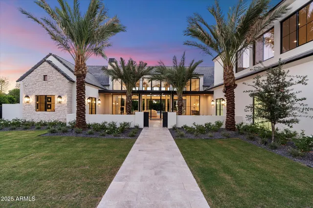 a front view of a house with a garden and yard