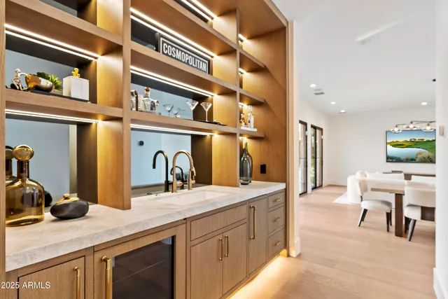 a kitchen with a dining table chairs and wooden floor