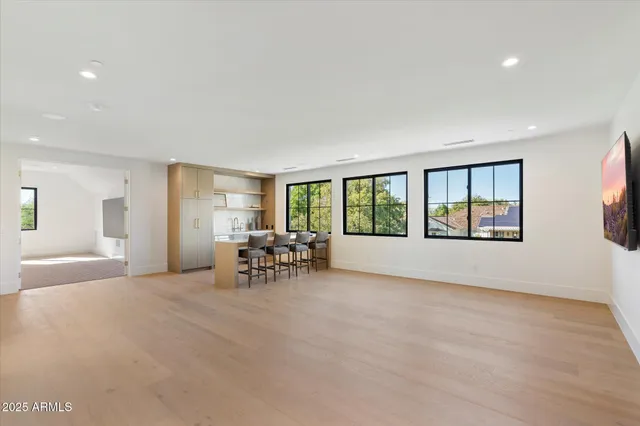 a view of a livingroom with wooden floor and a flat screen tv