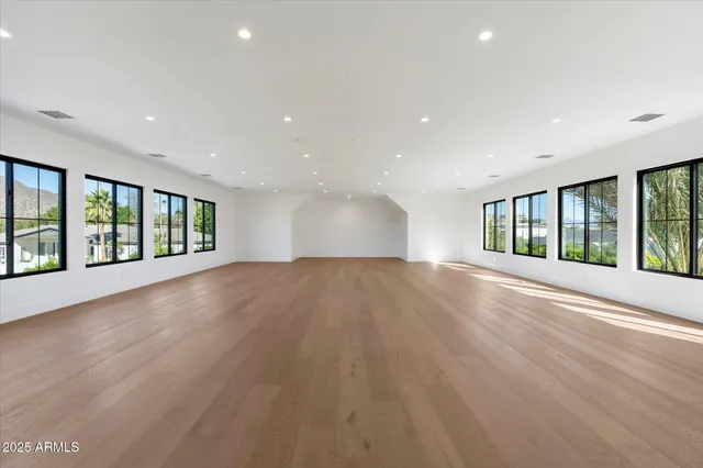 a view of a livingroom with wooden floor and a window