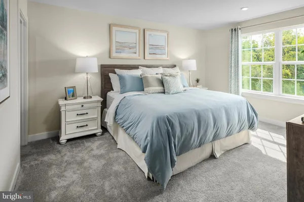 a spacious bedroom with a bed and a window