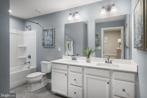 a bathroom with a toilet sink a shower and a mirror