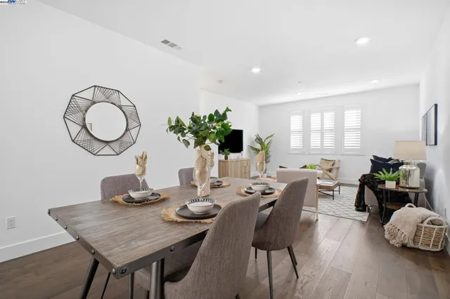 a view of a dining room with furniture window and wooden floor