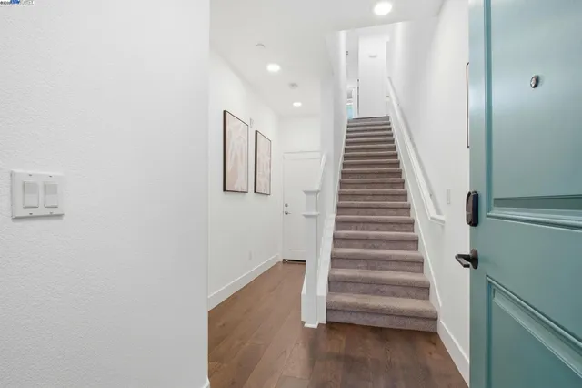 a view of entryway and hall with wooden floor