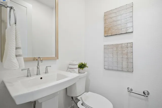 a bathroom with a sink mirror and toilet