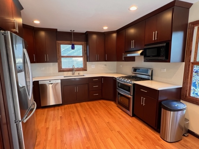 1006 North Delphia Avenue Park Ridge, IL 60068 - Photo 7 of 28 a kitchen with stainless steel appliances granite countertop a stove a sink dishwasher a refrigerator and a oven with wooden floor