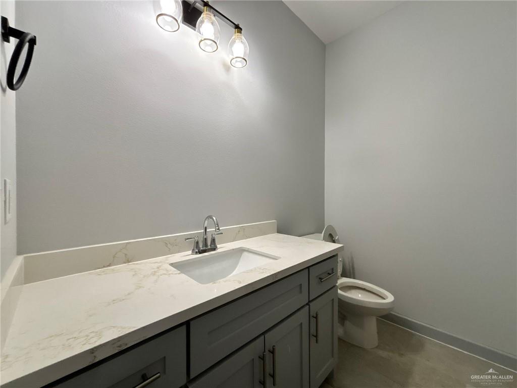 921 Jay Avenue, Unit 5 Mission, TX 78572 - Photo 6 of 8 a bathroom with a sink toilet and vanity