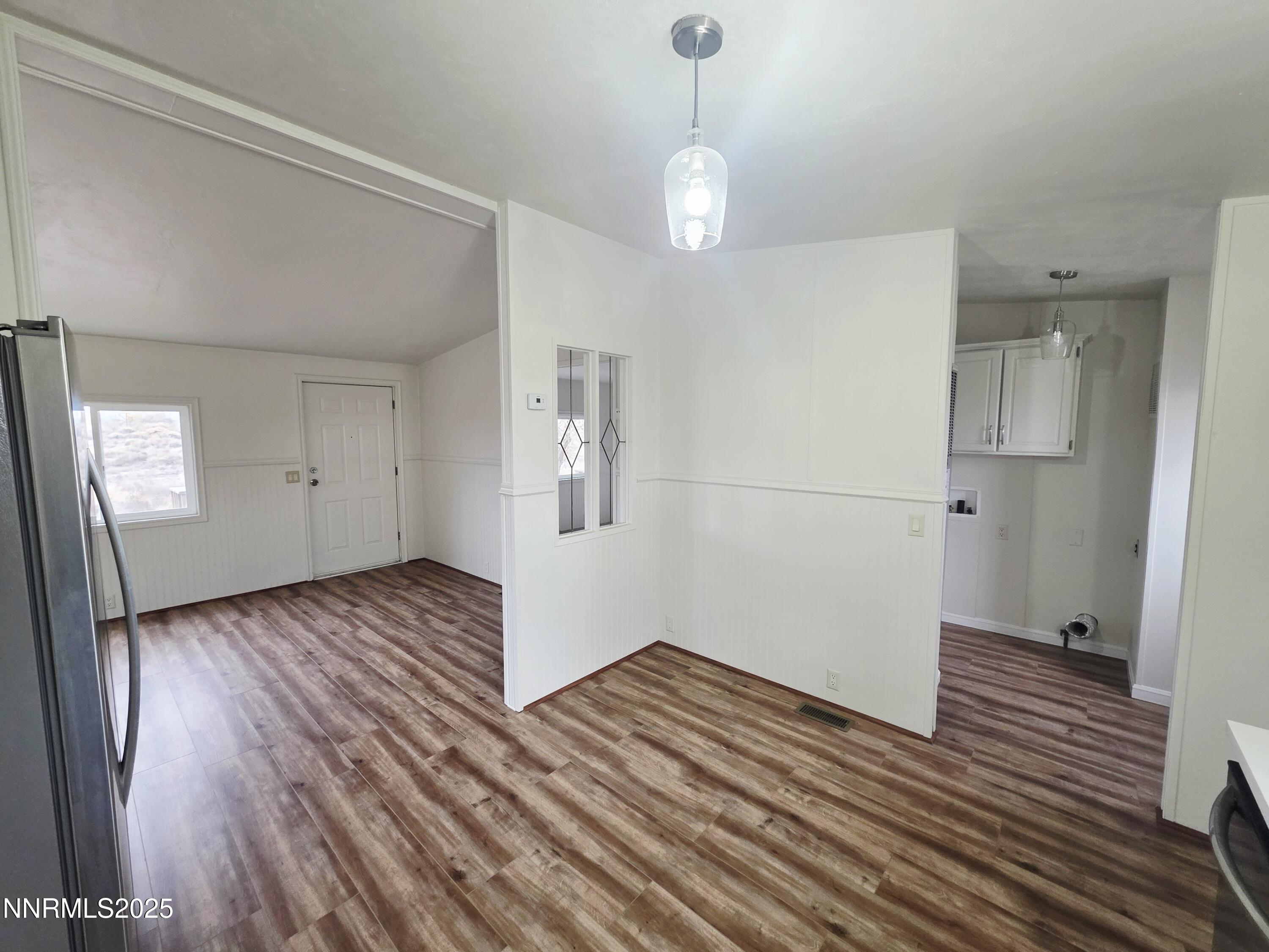 3146 Lone Tree Road Fallon, NV 89406 - Photo 13 of 23 an empty room with wooden floor and mirror