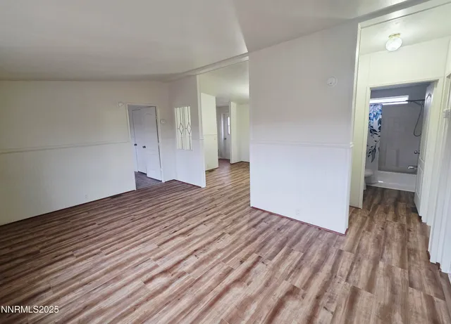 a view of a room with wooden floor and a sink