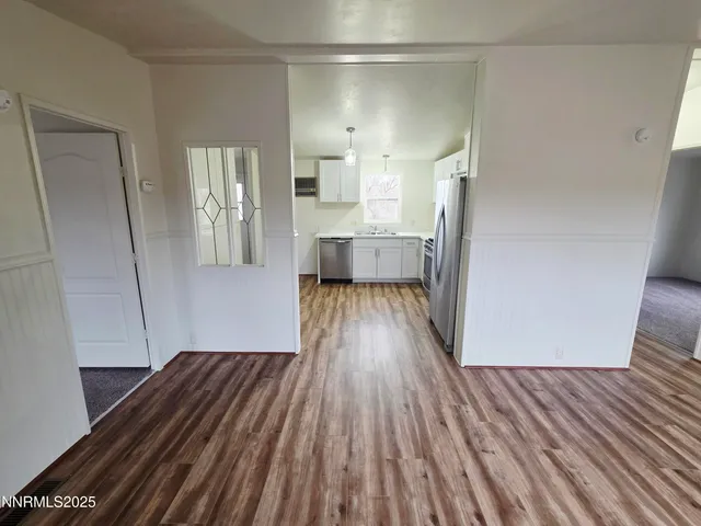 a view of a room with wooden floor and a window