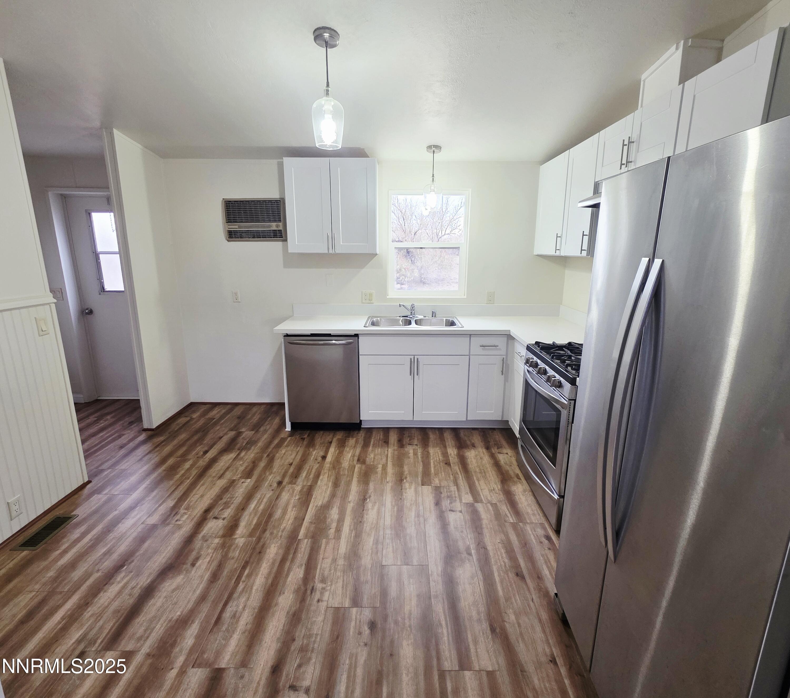 3146 Lone Tree Road Fallon, NV 89406 - Photo 10 of 23 a kitchen with wooden floor and refrigerator
