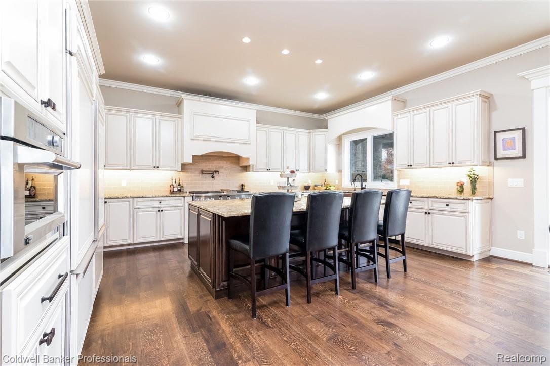 3762 Thatcher Drive Rochester, MI 48309 - Photo 12 of 76 Gourmet cook's kitchen with built in Miele coffee maker, 6 burner stove with dual ovens and pot filler, dual oven/microwave, two refrigerators, two freezers, trash compactor, pop up heavy duty lift for KitchenAid mixer