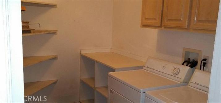 12858 Rain Shadow Road Victorville, CA 92395 - Photo 6 of 15 a utility room with dryer and washer
