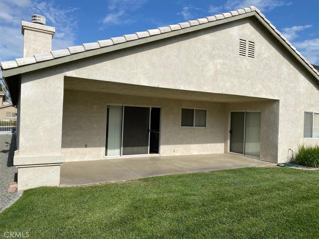 12858 Rain Shadow Road Victorville, CA 92395 - Photo 7 of 15 a front view of a house with a yard