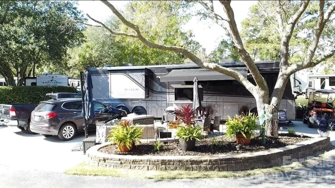 43B Jenkins Island Road, Unit 177 Hilton Head Island, SC 29926 - Photo 12 of 18 a front view of a house with a yard patio and fire pit