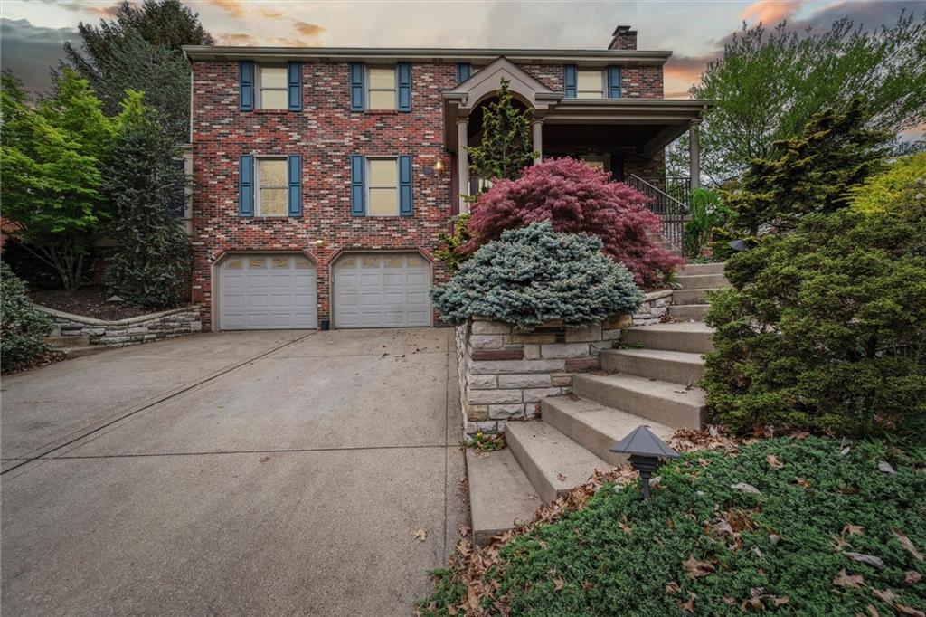 a front view of a house with plants
