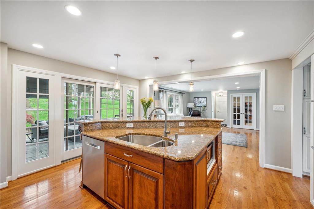 2336 Mill Grove Road Pittsburgh, PA 15241 - Photo 14 of 44 a dining hall with stainless steel appliances granite countertop a sink and dishwasher a refrigerator with wooden floor