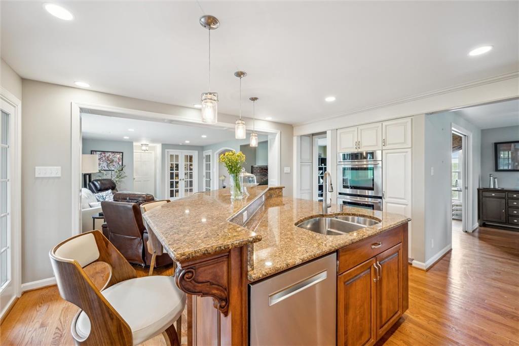 2336 Mill Grove Road Pittsburgh, PA 15241 - Photo 16 of 44 a kitchen with granite countertop kitchen island stainless steel appliances a dining table and chairs