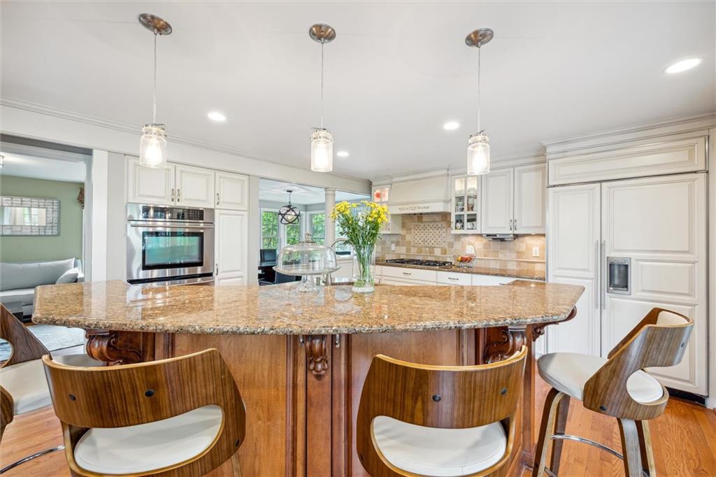 2336 Mill Grove Road Pittsburgh, PA 15241 - Photo 17 of 44 a kitchen with stainless steel appliances kitchen island granite countertop a kitchen island and chairs