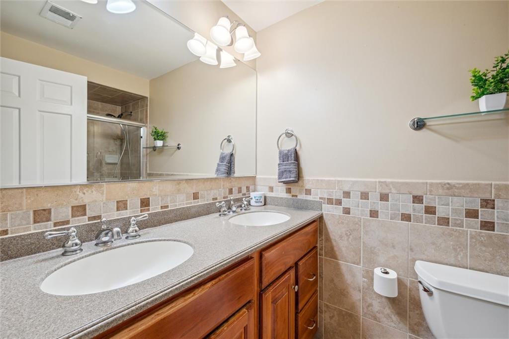 2336 Mill Grove Road Pittsburgh, PA 15241 - Photo 26 of 44 a bathroom with a granite countertop double vanity and a mirror