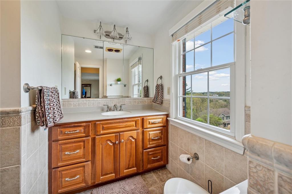 2336 Mill Grove Road Pittsburgh, PA 15241 - Photo 28 of 44 a bathroom with a granite countertop sink a window and a mirror