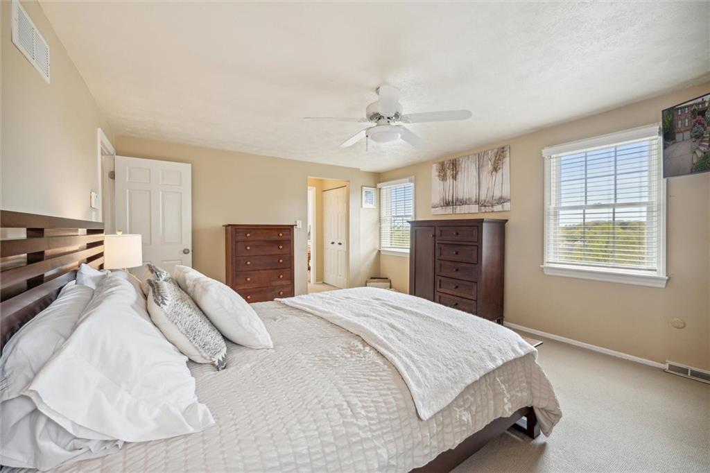 2336 Mill Grove Road Pittsburgh, PA 15241 - Photo 32 of 44 a spacious bedroom with a bed and a chandelier