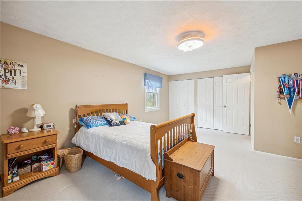 2336 Mill Grove Road Pittsburgh, PA 15241 - Photo 35 of 44 a bedroom with a bed and a chandelier