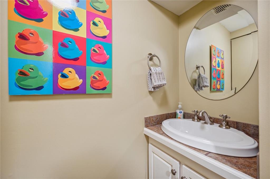 2336 Mill Grove Road Pittsburgh, PA 15241 - Photo 36 of 44 a bathroom with a sink a mirror and painting on the wall