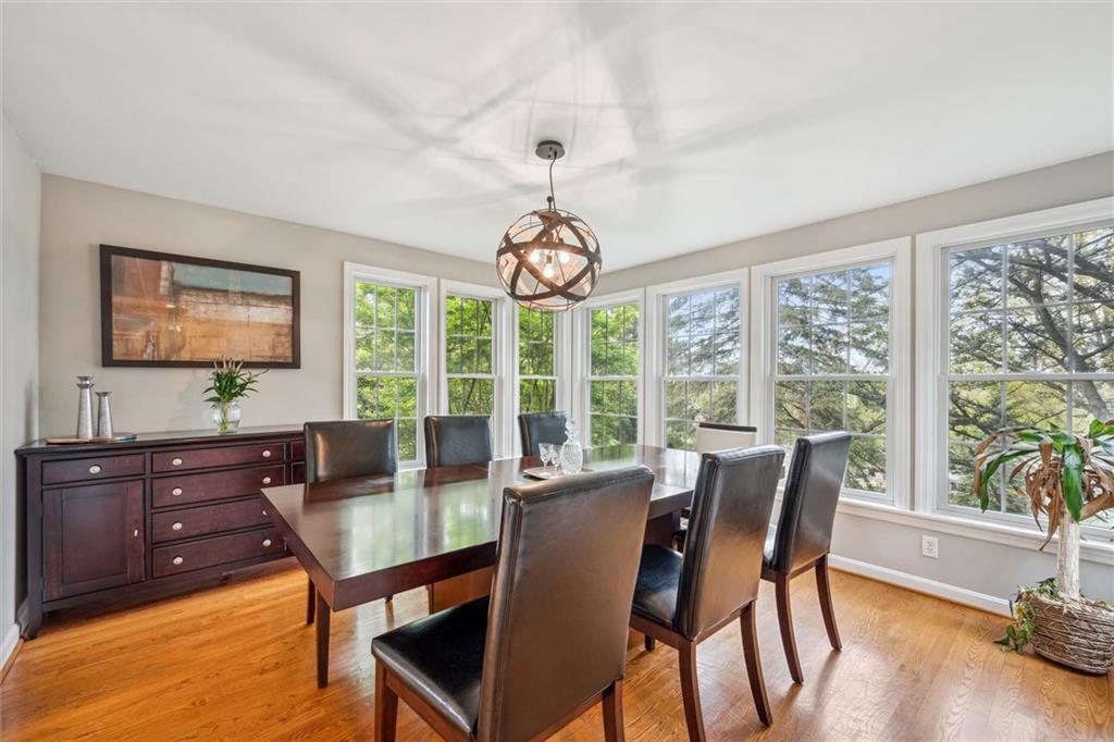 2336 Mill Grove Road Pittsburgh, PA 15241 - Photo 10 of 44 a dining room with wooden floor a chandelier a glass table and chairs