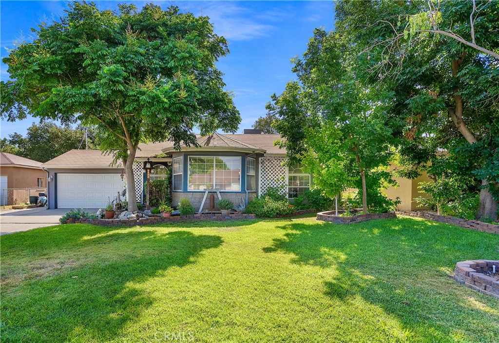 6964 Barcelona Way Riverside, CA 92504 - Photo 1 of 1 a front view of a house with a yard and trees