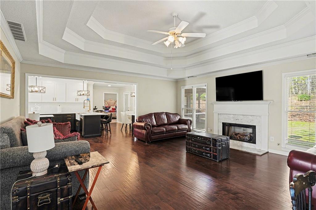 570 Morgan Court Hampton, GA 30228 - Photo 8 of 31 a living room with furniture a fireplace and a flat screen tv