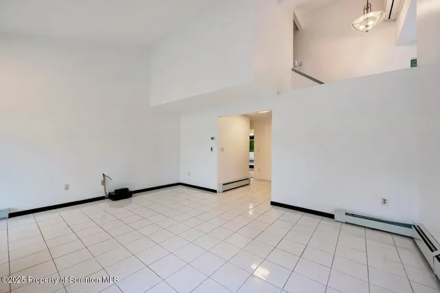 a view of an empty room with a fireplace