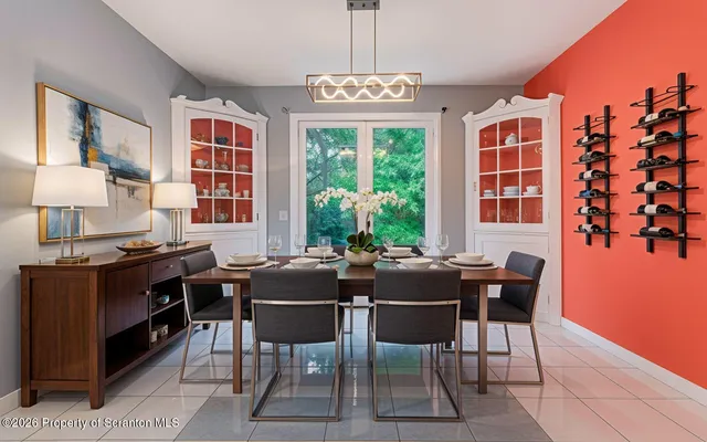 a bedroom with a bed and a refrigerator