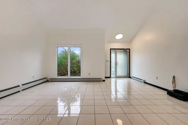 a large white kitchen with stainless steel appliances granite countertop a sink and dishwasher a stove top oven with white cabinets