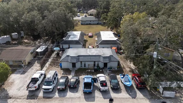 an aerial view of a house with a lot of trees