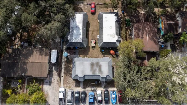 a front view of a house with a yard and fountain in middle
