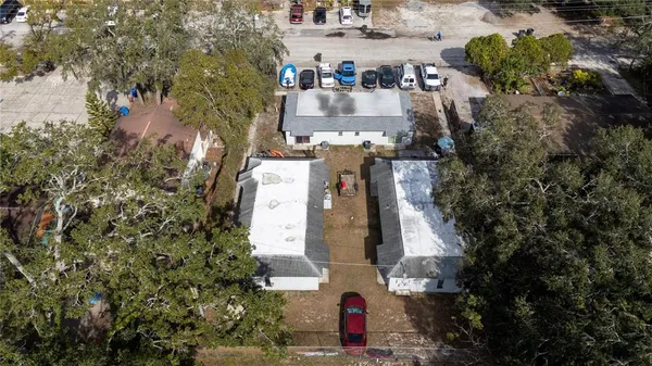 an aerial view of a house with a yard basket ball court and outdoor seating