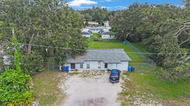 a aerial view of a house with swimming pool and garden