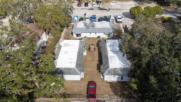 an aerial view of a house with a yard