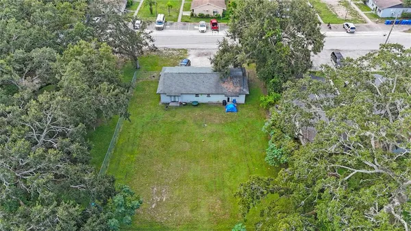 an aerial view of residential houses with outdoor space and street view