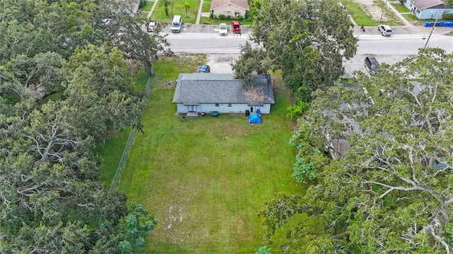 an aerial view of residential houses with outdoor space and street view