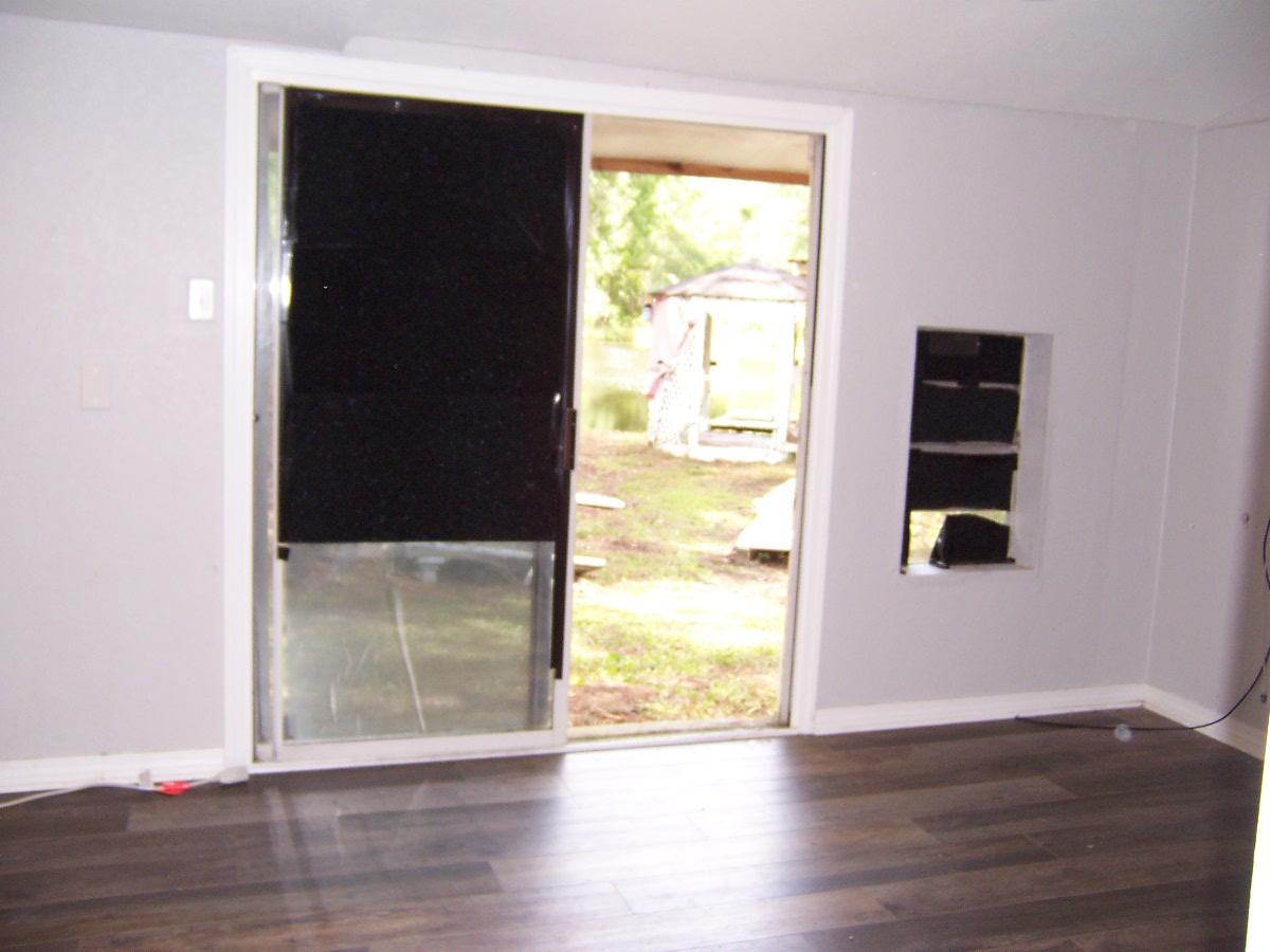5337 Old River Road Baker, FL 32531 - Photo 60 of 61 a view of an empty room with wooden floor and a window