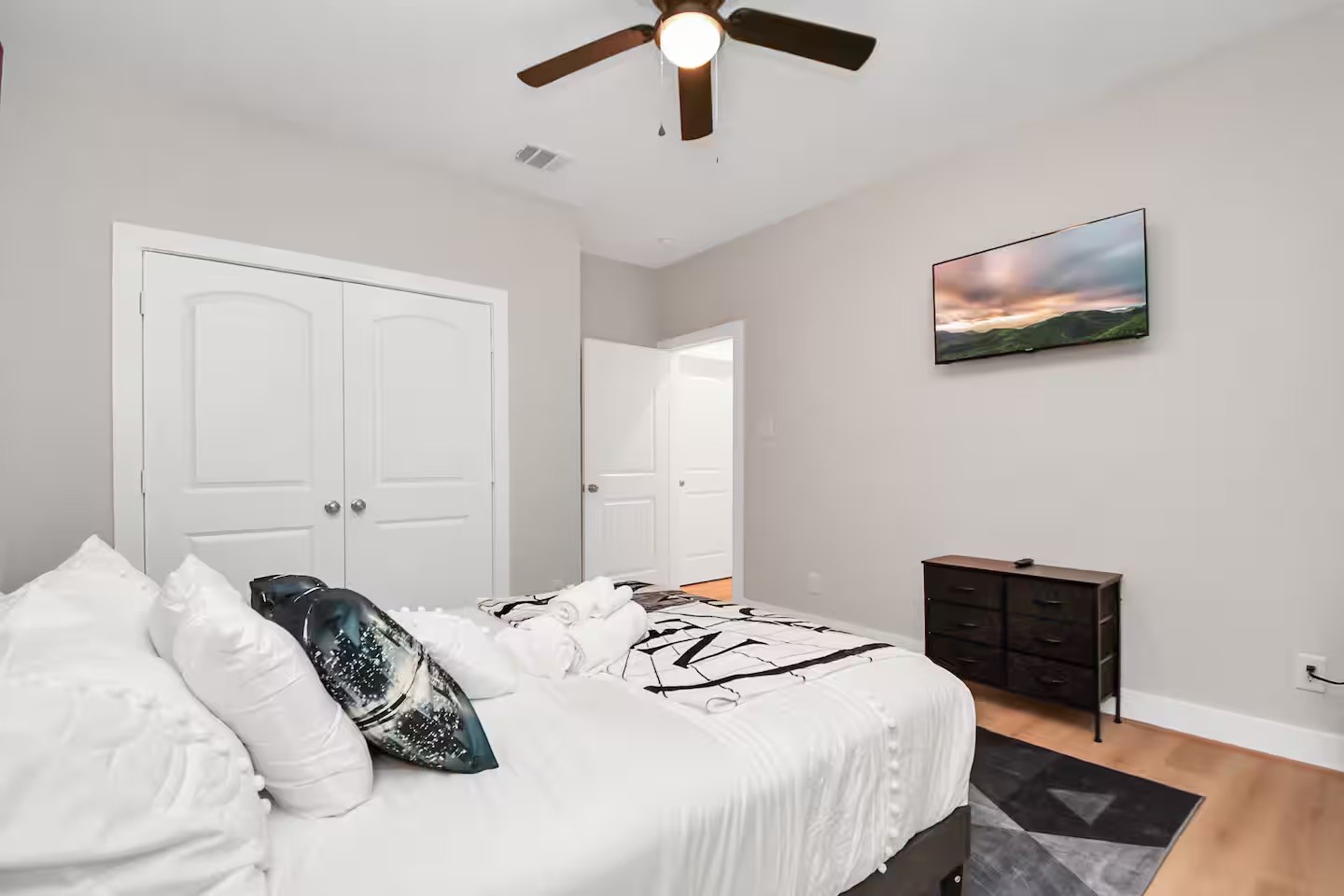 5718 Beall Street, Unit D Houston, TX 77091 - Photo 31 of 41 a bedroom with a bed and a lamp on dresser