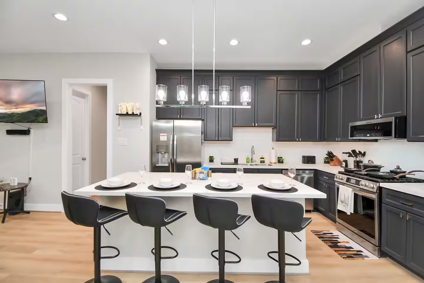 5718 Beall Street, Unit D Houston, TX 77091 - Photo 6 of 41 a kitchen with stainless steel appliances kitchen island granite countertop a stove a sink a dining table and chairs